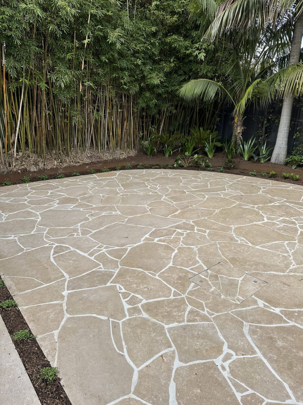 Crazy paving courtyard with bamboo screen